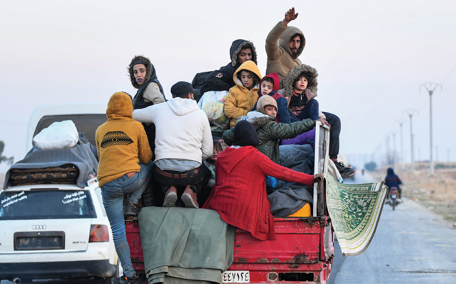 Syrian Kurds flee from Aleppo with their belongings on Dec. 2 after HTS forces seized control of the city.
