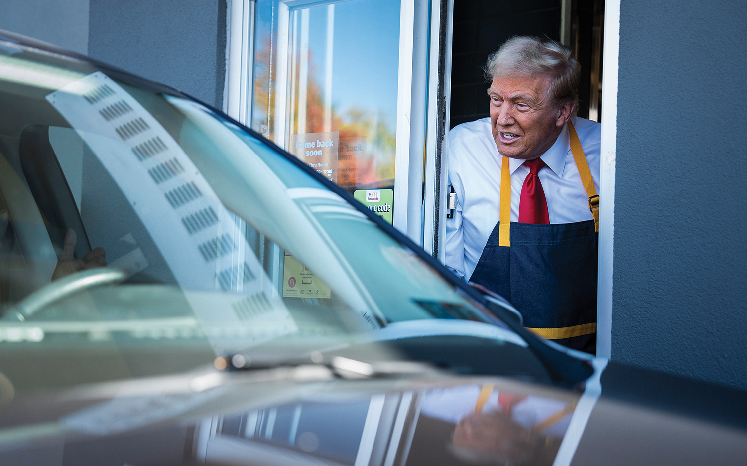 Donald Trump hands out food at a McDonald's drive-thru window during a campaign stop in Feasterville-Trevose, Pa.