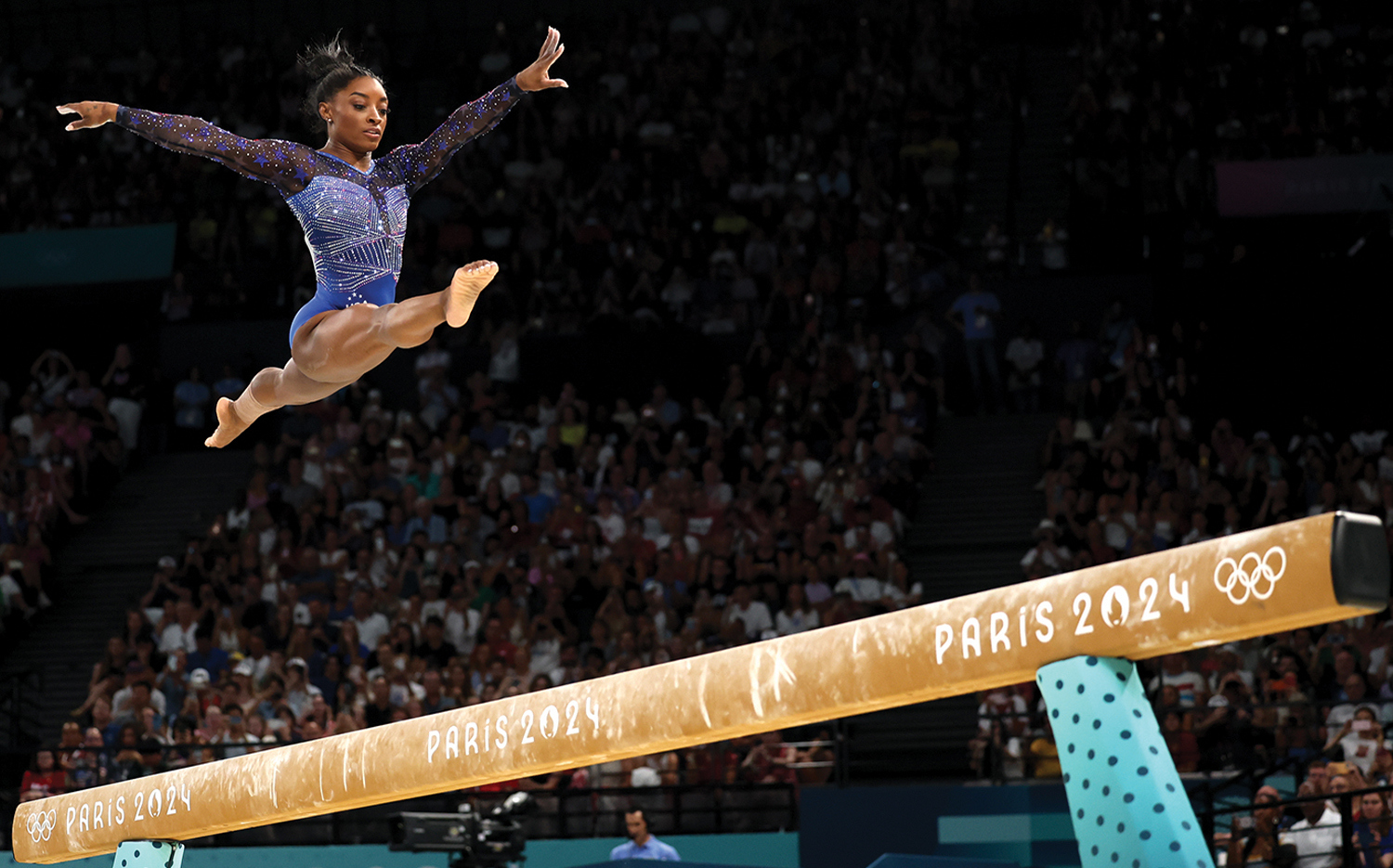 Simone Biles competes on the balance beam during the women's gymnastics all-around final.