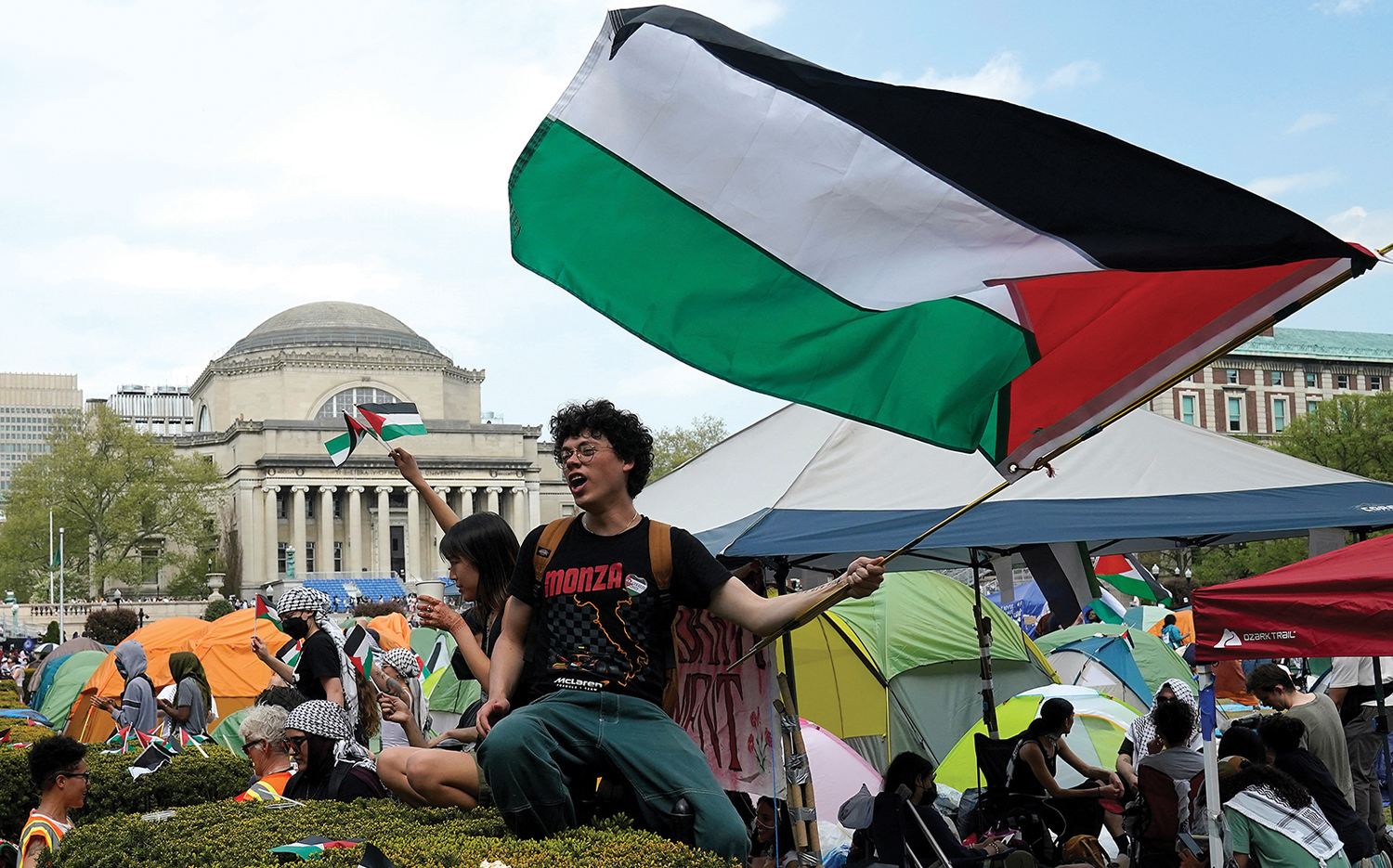 Protesters wave Palestinian flags on the West Lawn of Columbia University on April 29 in New York.